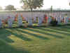 Long shadows in the morning sun formed by rows of gravestones